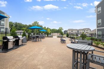 A sunny day at the outdoor seating area of a building at Aventura at Wentzville I & II Apartments, Missouri, 63385